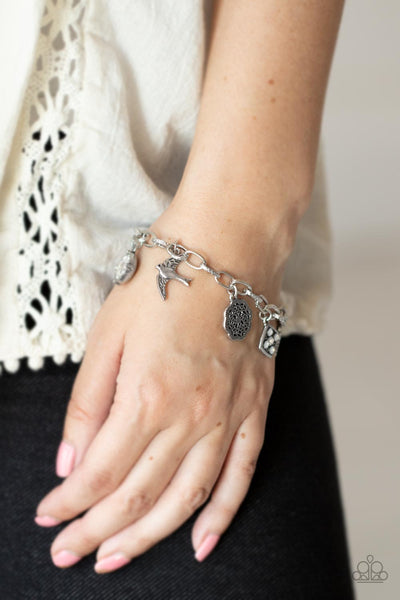 Fancifully Flighty - Paparazzi - White Rhinestone Silver Bird Feather Floral Charm Bracelet